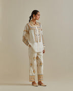 Yellow and off-white cotton chanderi embroidered shirt with full sleeves, paired with off white cotton straight pants with all over multi color embroidery detailed with sequins.