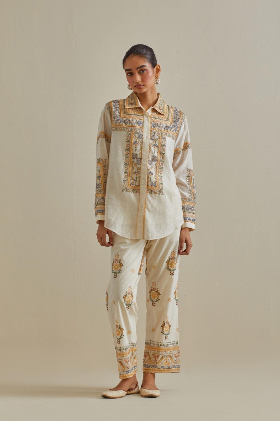 Yellow and off-white cotton chanderi embroidered shirt with full sleeves, paired with off white cotton straight pants with all over multi color embroidery detailed with sequins.