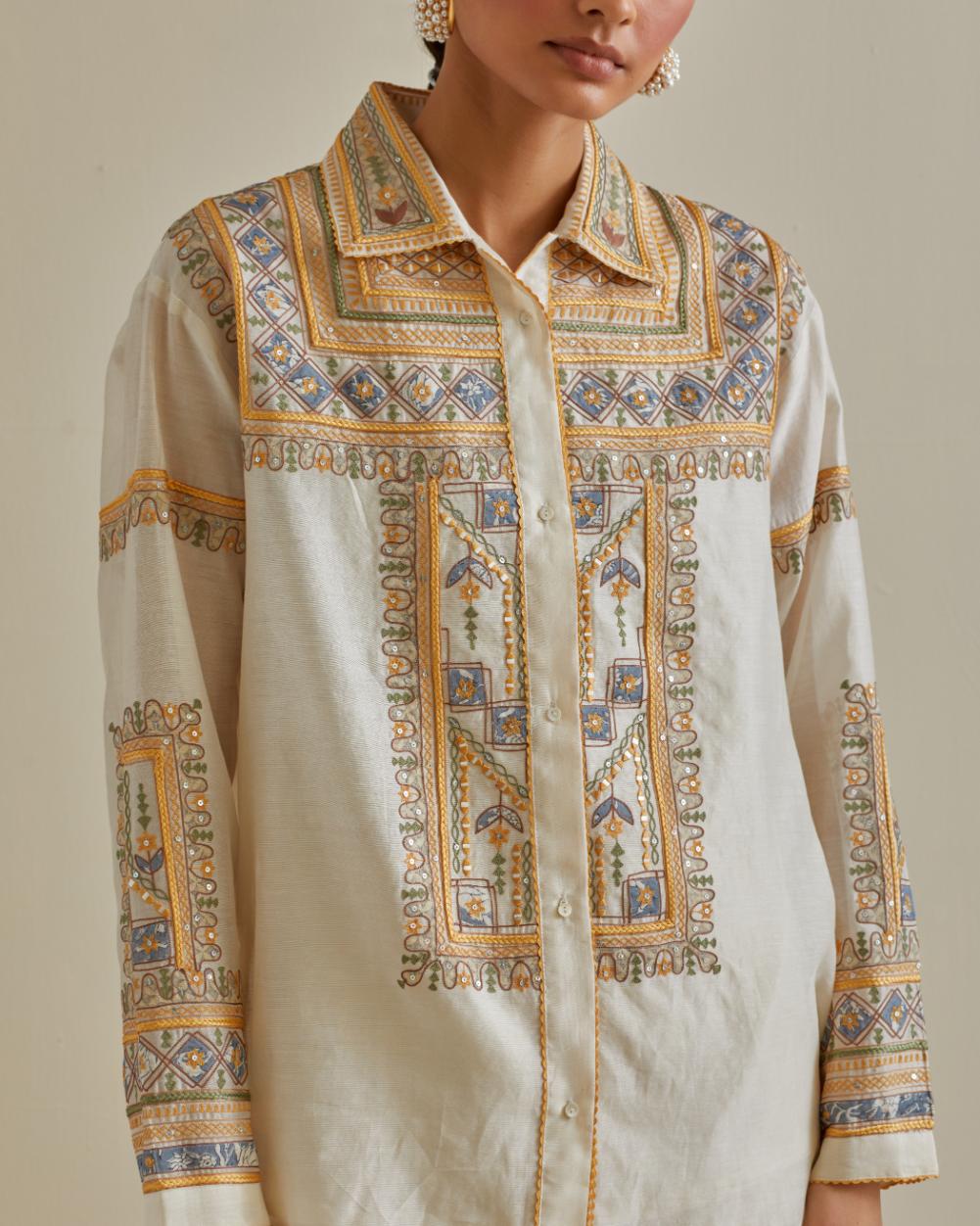 Yellow and off-white cotton chanderi embroidered shirt with full sleeves, paired with off white cotton straight pants with all over multi color embroidery detailed with sequins.