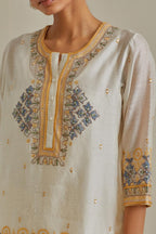 Yellow and off-white cotton chanderi embroidered short top with 3/4th sleeves, paired with off white cotton straight pants with all over multi color embroidery detailed with sequins.