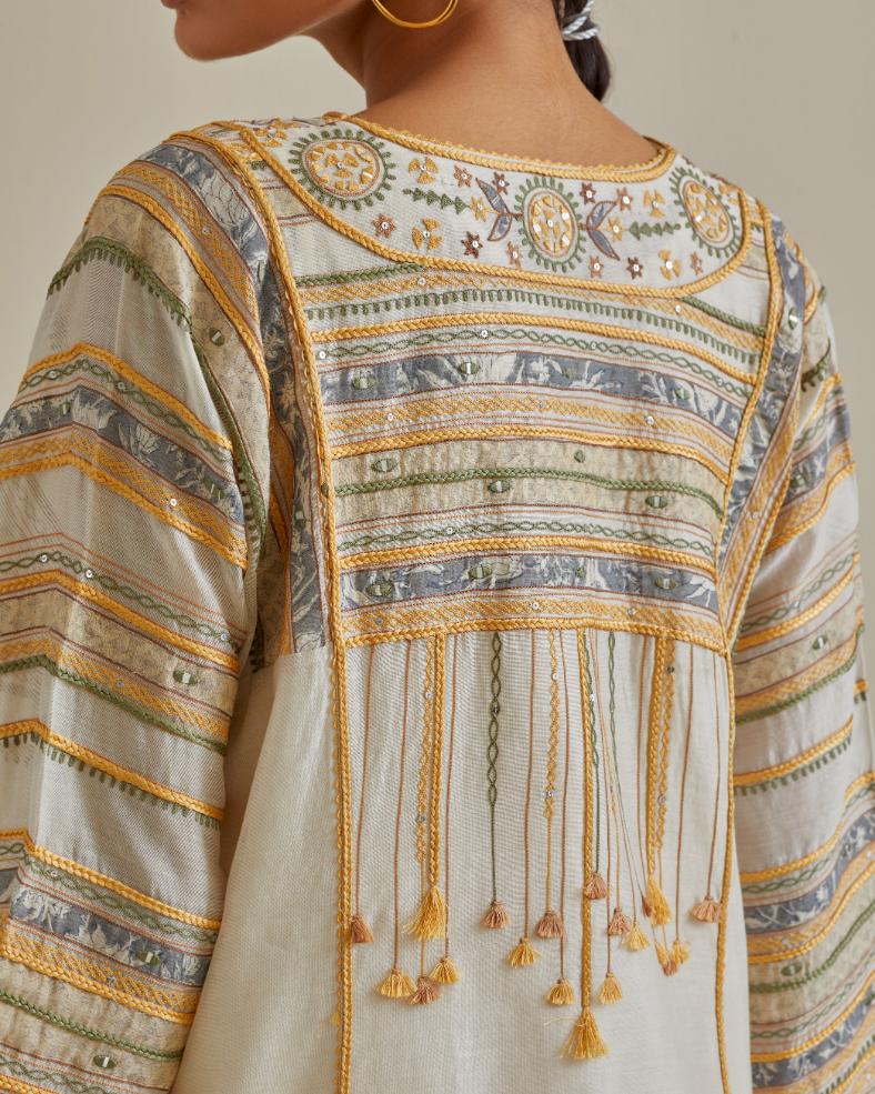 Yellow and off-white cotton chanderi easy fit long kaftan detailed with patch, silk thread, mirror & sequins work, paired with off white cotton straight pants with all over multi color embroidery detailed with sequins.