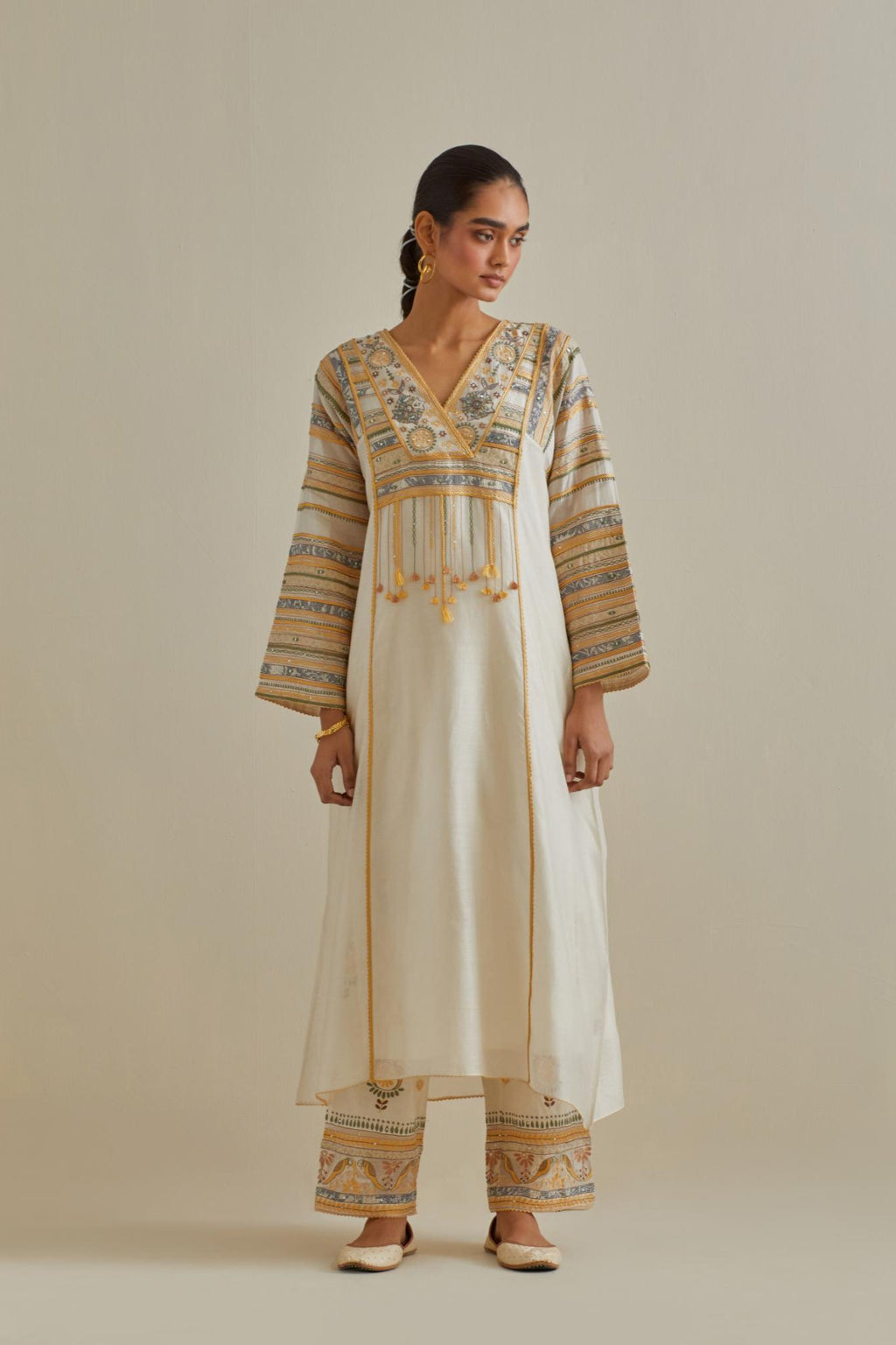 Yellow and off-white cotton chanderi easy fit long kaftan detailed with patch, silk thread, mirror & sequins work, paired with off white cotton straight pants with all over multi color embroidery detailed with sequins.