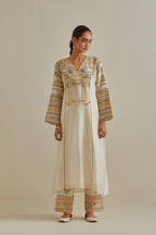 Yellow and off-white cotton chanderi easy fit long kaftan detailed with patch, silk thread, mirror & sequins work, paired with off white cotton straight pants with all over multi color embroidery detailed with sequins.