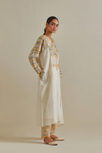 Yellow and off-white cotton chanderi easy fit long kaftan detailed with patch, silk thread, mirror & sequins work, paired with off white cotton straight pants with all over multi color embroidery detailed with sequins.