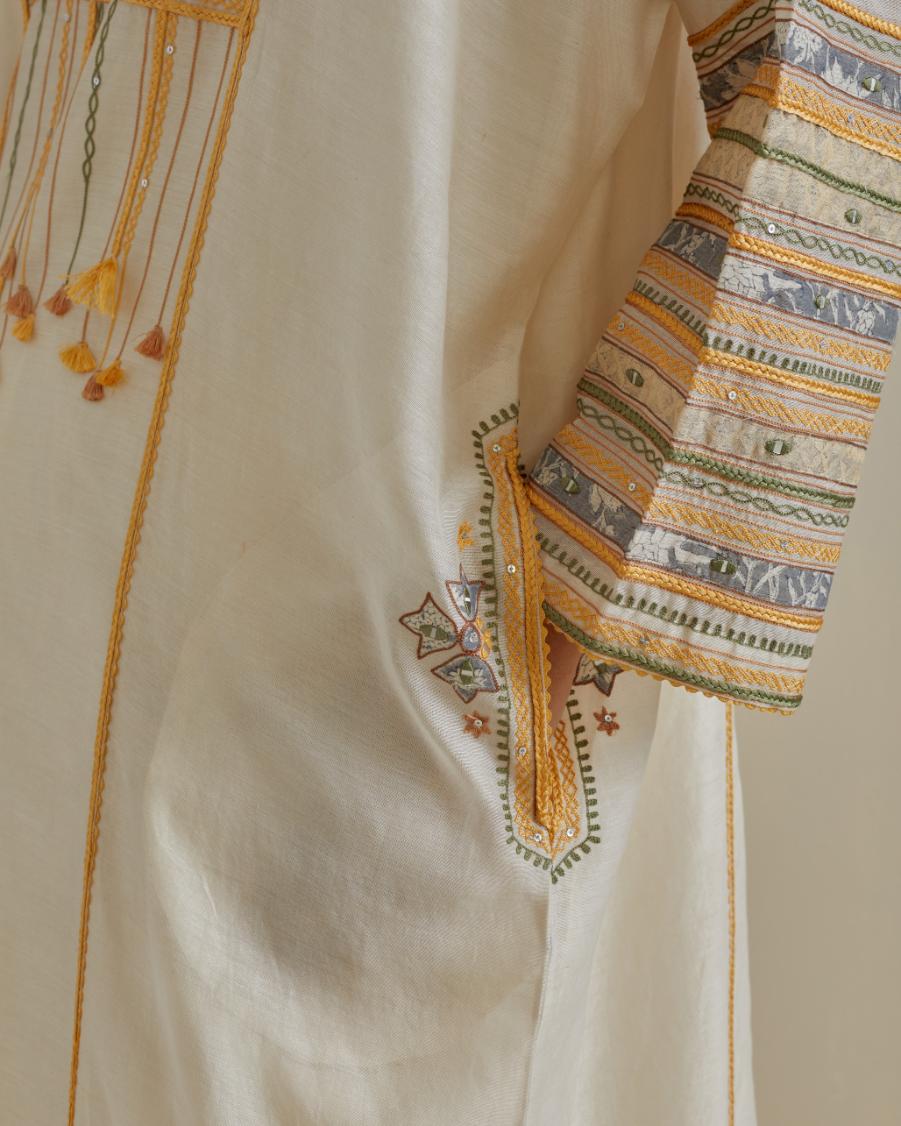 Yellow and off-white cotton chanderi easy fit long kaftan detailed with patch, silk thread, mirror & sequins work, paired with off white cotton straight pants with all over multi color embroidery detailed with sequins.