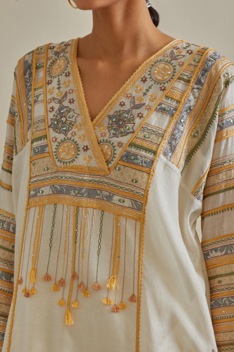 Yellow and off-white cotton chanderi easy fit long kaftan detailed with patch, silk thread, mirror & sequins work, paired with off white cotton straight pants with all over multi color embroidery detailed with sequins.