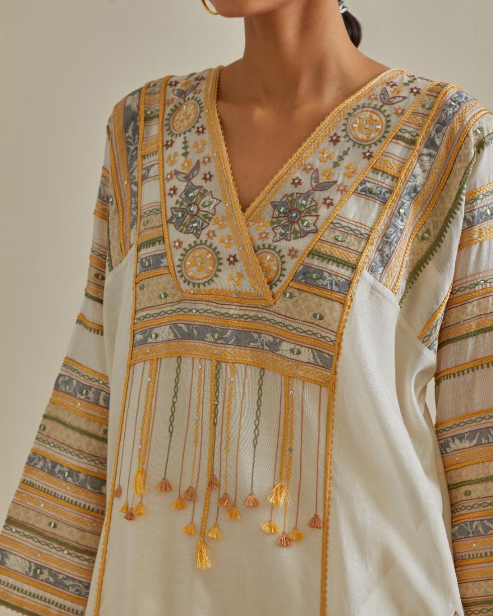 Yellow and off-white cotton chanderi easy fit long kaftan detailed with patch, silk thread, mirror & sequins work, paired with off white cotton straight pants with all over multi color embroidery detailed with sequins.