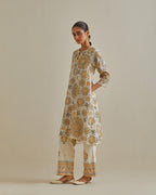 Yellow and off-white A-line cotton chanderi kurta set with all over patchwork, silk thread, mirror, tassels and sequin embroidery.