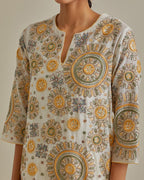 Yellow and off-white A-line cotton chanderi kurta set with all over patchwork, silk thread, mirror, tassels and sequin embroidery.