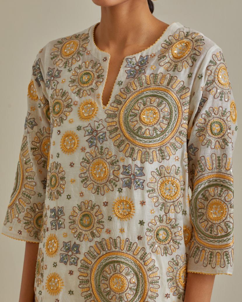 Yellow and off-white A-line cotton chanderi kurta set with all over patchwork, silk thread, mirror, tassels and sequin embroidery.
