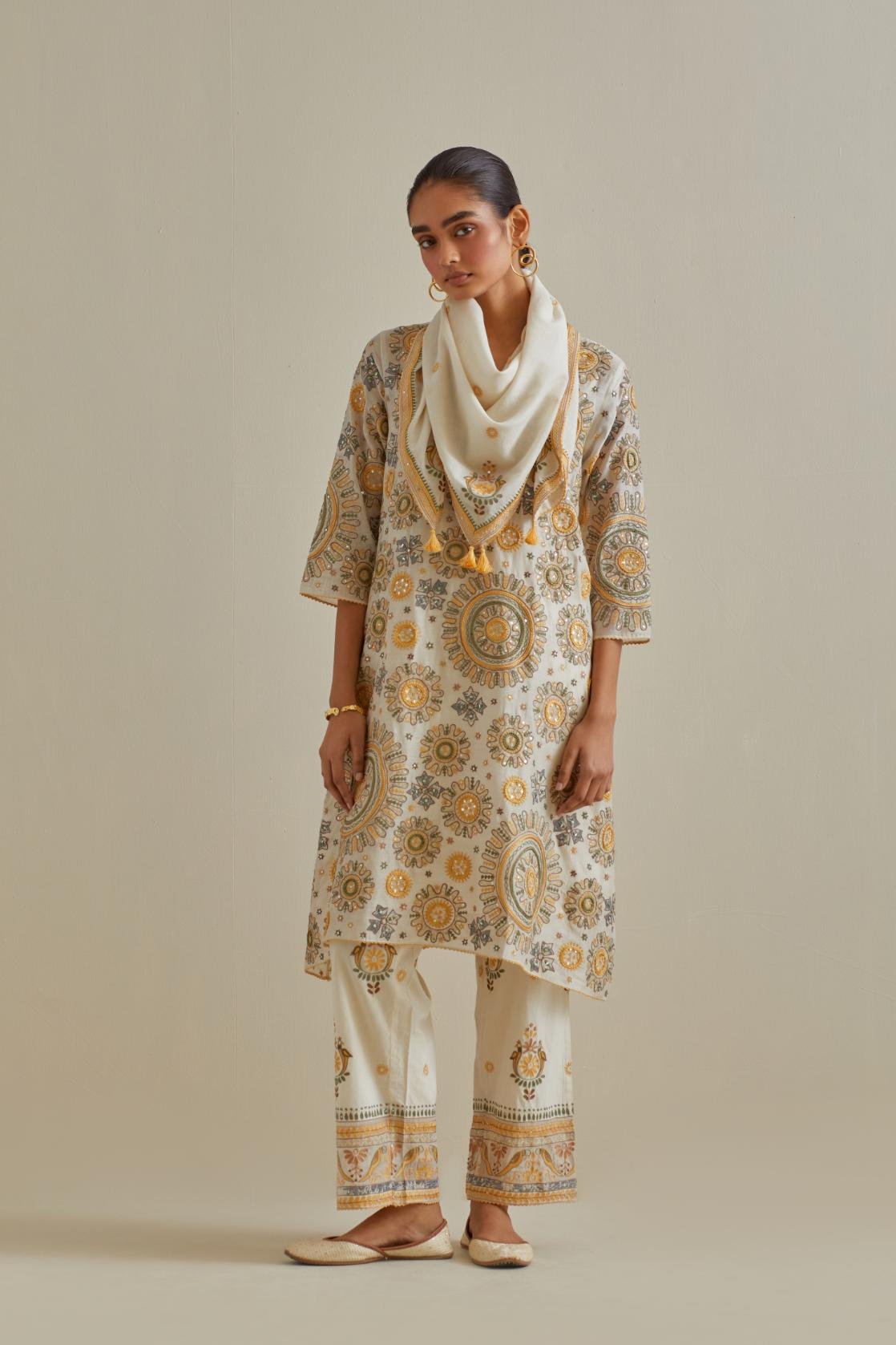 Yellow and off-white A-line cotton chanderi kurta set with all over patchwork, silk thread, mirror, tassels and sequin embroidery.