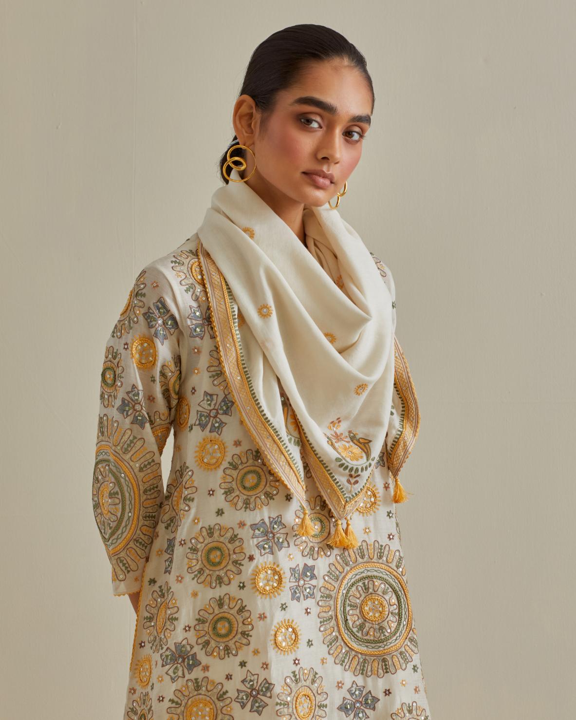 Yellow and off-white A-line cotton chanderi kurta set with all over patchwork, silk thread, mirror, tassels and sequin embroidery.