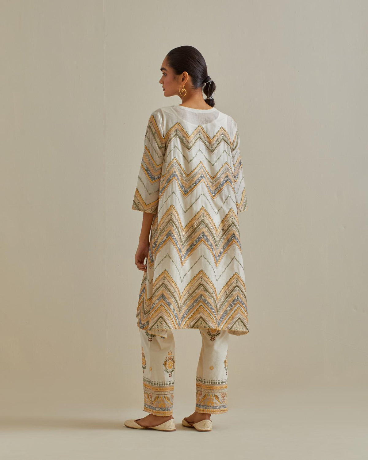 Yellow and off-white cotton chanderi A-line kurta set with all over embroidery set in bold chevron stripes.
