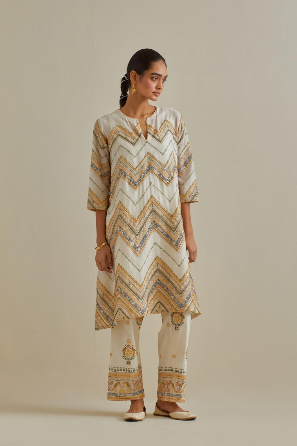 Yellow and off-white cotton chanderi A-line kurta set with all over embroidery set in bold chevron stripes.