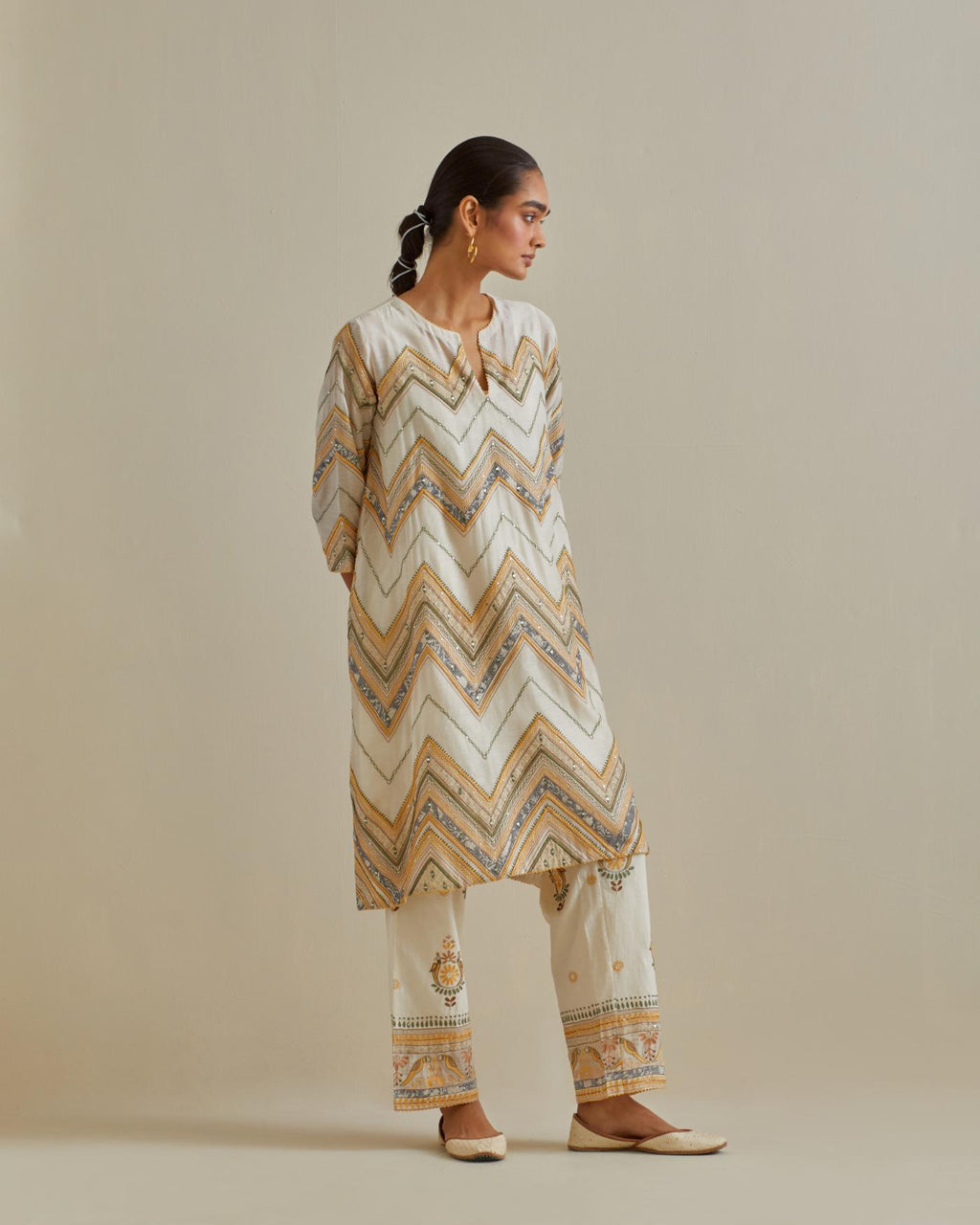 Yellow and off-white cotton chanderi A-line kurta set with all over embroidery set in bold chevron stripes.