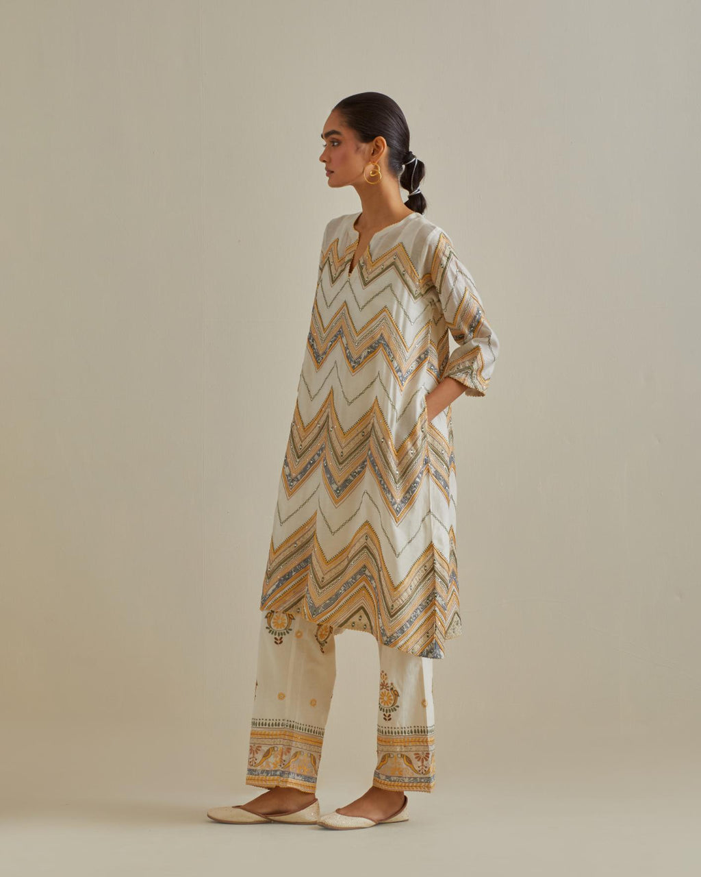 Yellow and off-white cotton chanderi A-line kurta set with all over embroidery set in bold chevron stripes.