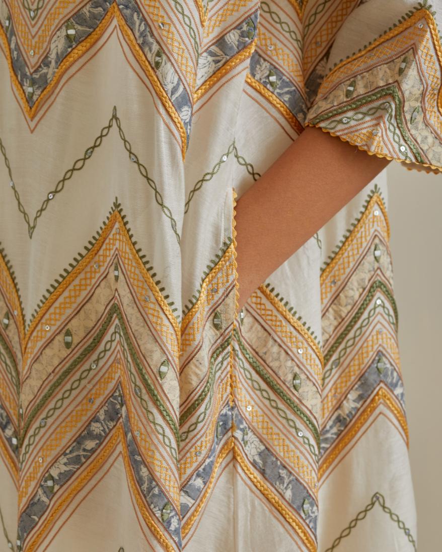Yellow and off-white cotton chanderi A-line kurta set with all over embroidery set in bold chevron stripes.