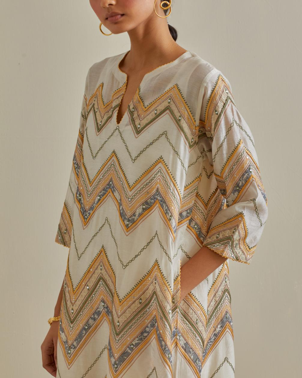 Yellow and off-white cotton chanderi A-line kurta set with all over embroidery set in bold chevron stripes.