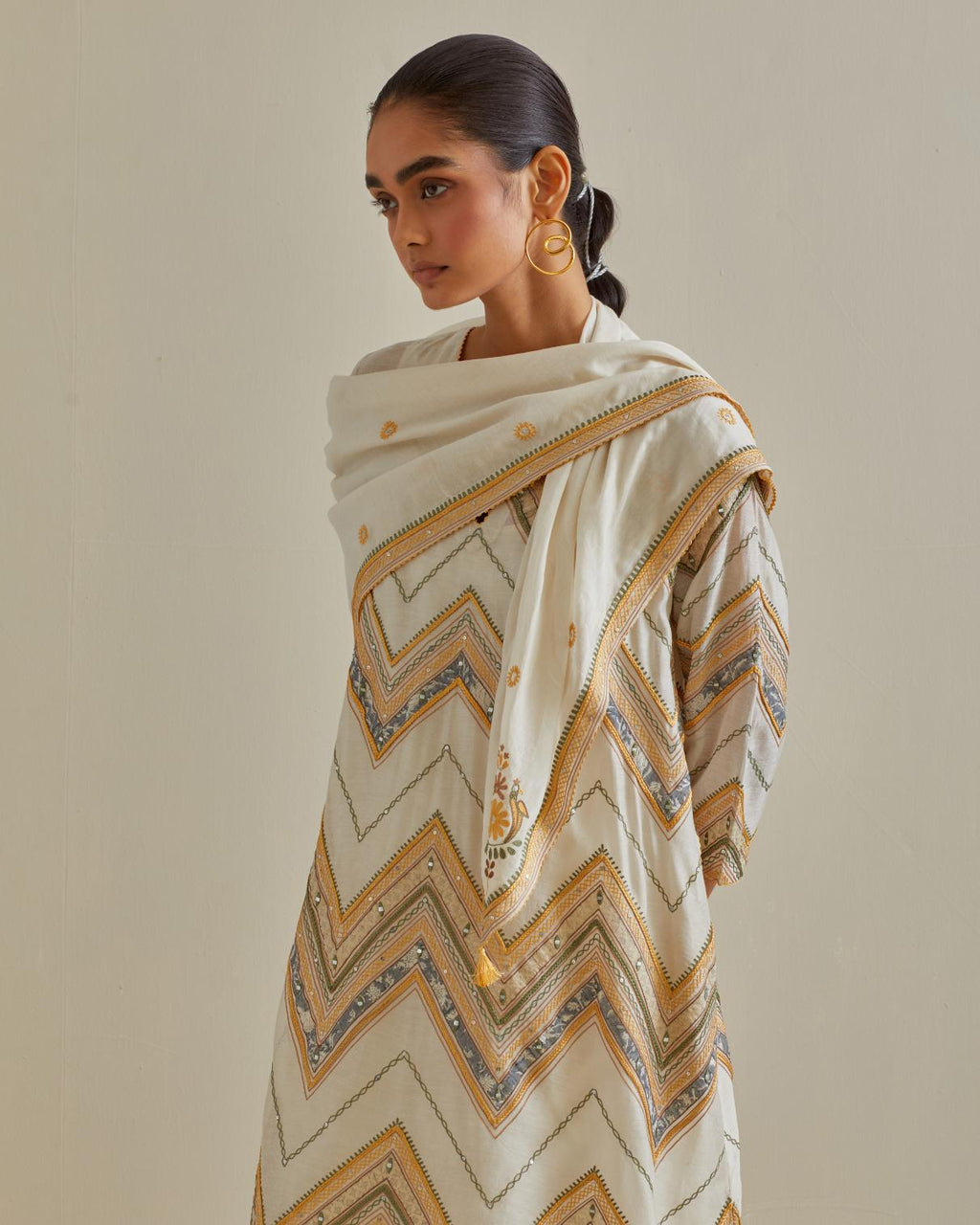 Yellow and off-white cotton chanderi A-line kurta set with all over embroidery set in bold chevron stripes.