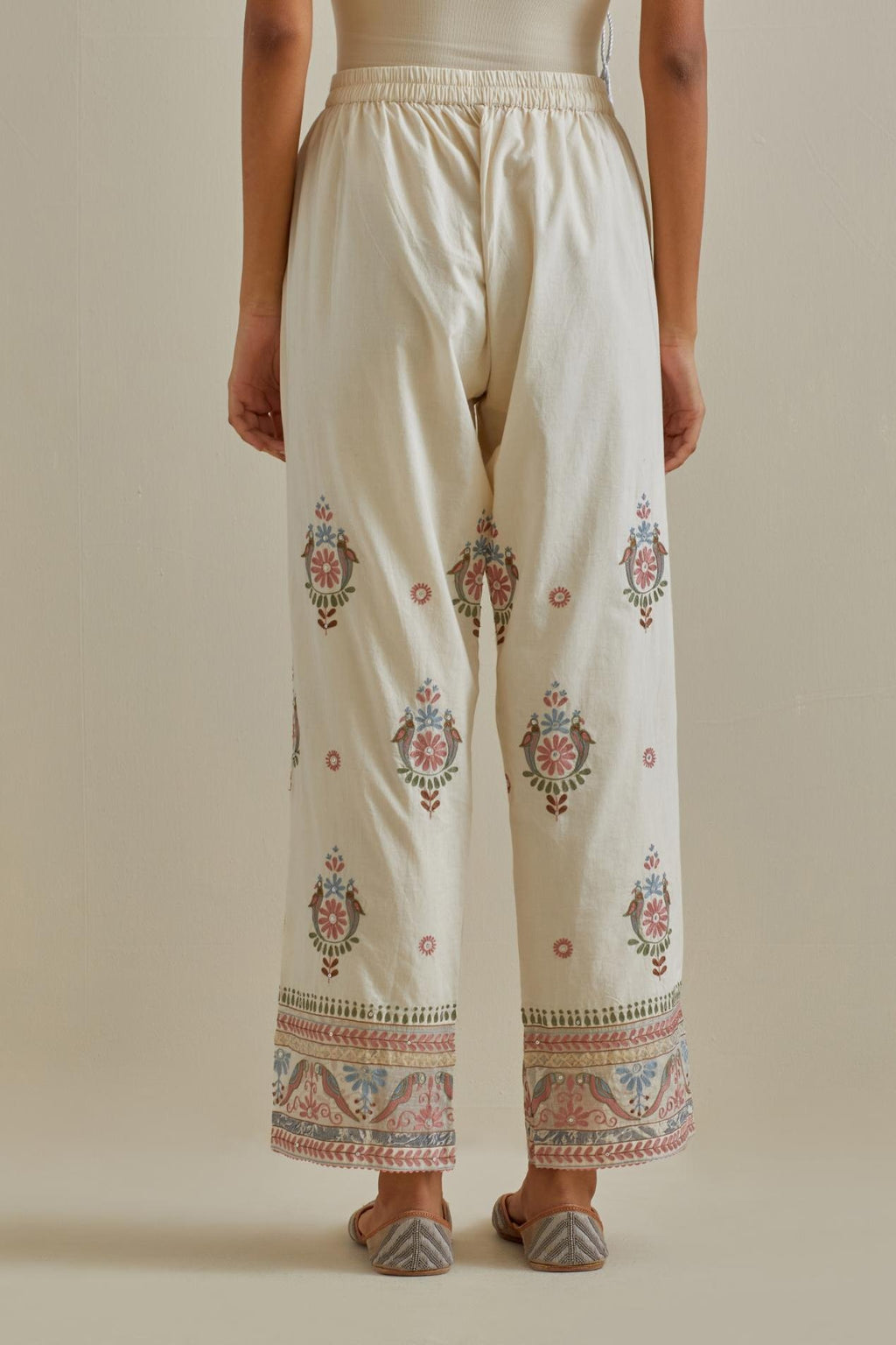 Pink and off-white straight pants with all over multi color embroidery detailed with sequins.