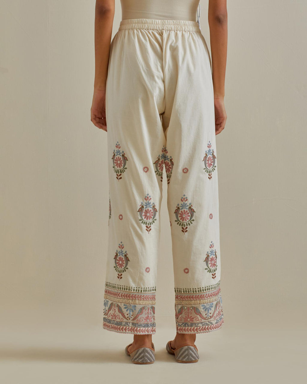 Pink and off-white straight pants with all over multi color embroidery detailed with sequins.