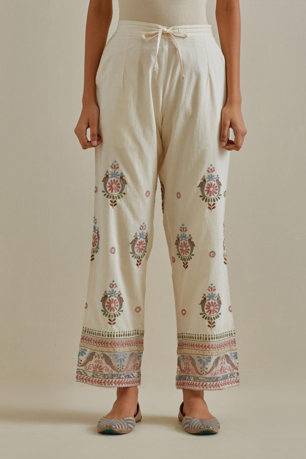 Pink and off-white straight pants with all over multi color embroidery detailed with sequins.