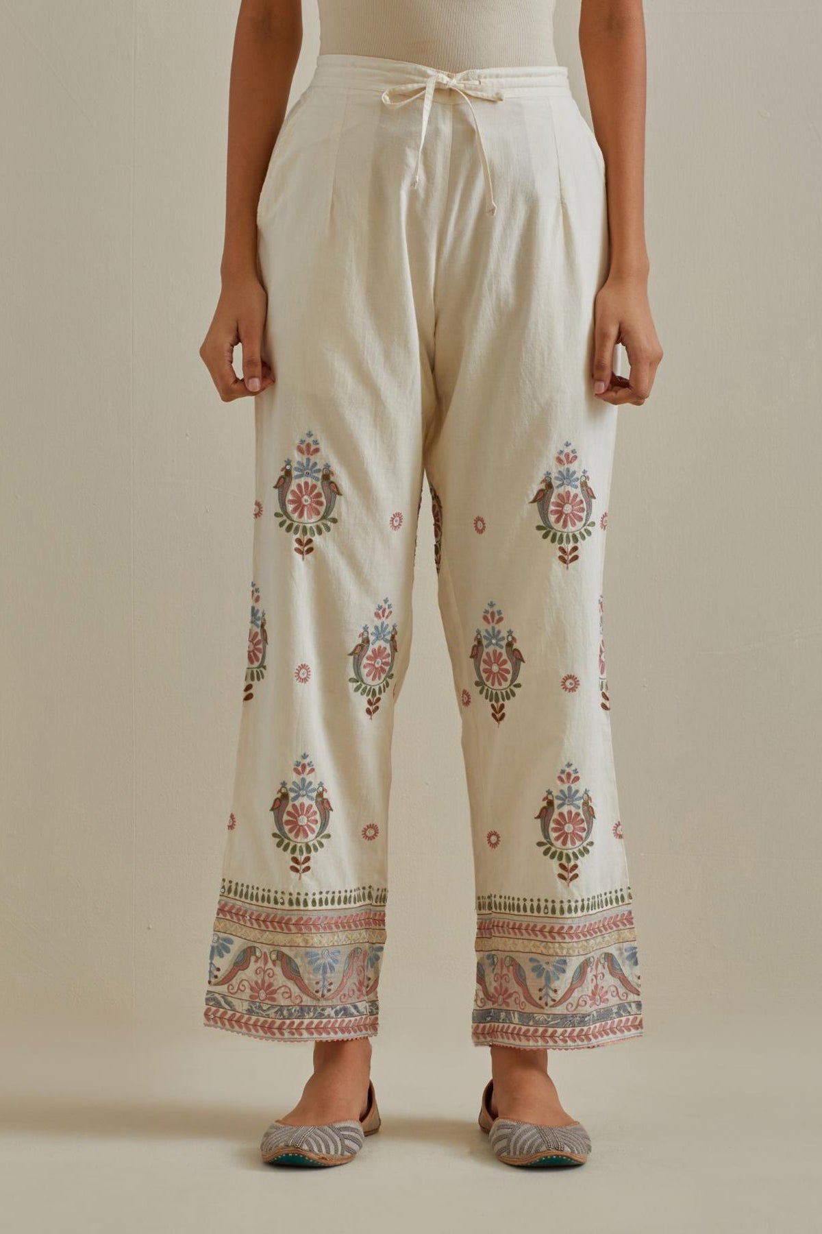 Pink and off-white straight pants with all over multi color embroidery detailed with sequins.
