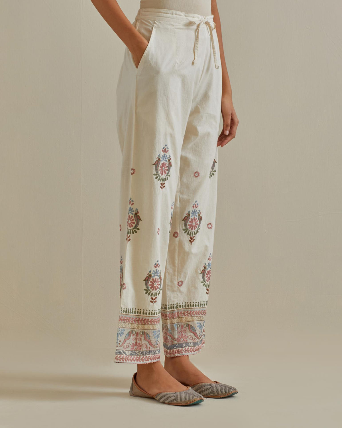 Pink and off-white straight pants with all over multi color embroidery detailed with sequins.