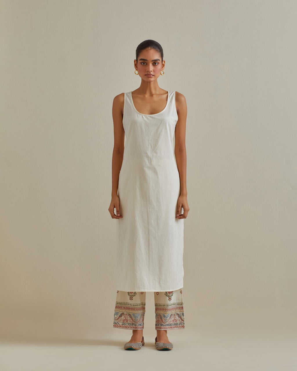 Pink and off-white cotton chanderi straight kurta set with yoke with patchwork and silk thread embroidery highlighted with mirror, sequins, tassels and braids.