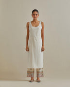 Pink and off-white cotton chanderi straight kurta set with yoke with patchwork and silk thread embroidery highlighted with mirror, sequins, tassels and braids.