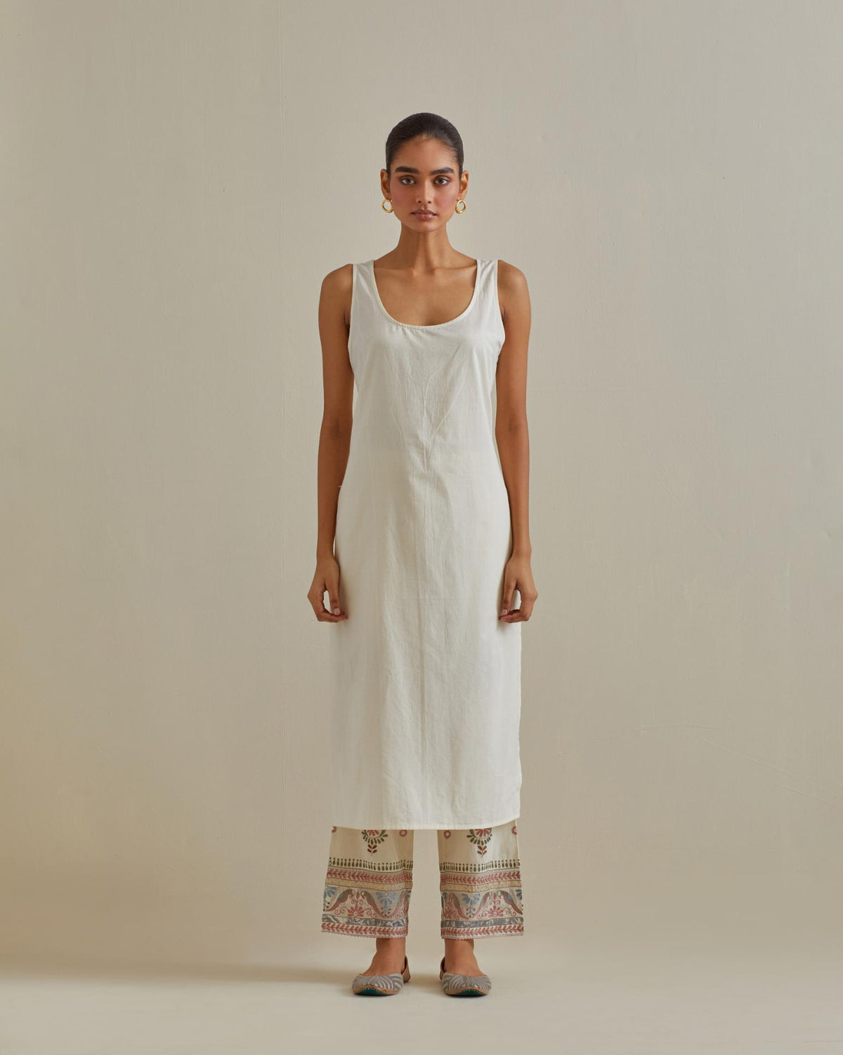 Pink and off-white cotton chanderi straight kurta set with yoke with patchwork and silk thread embroidery highlighted with mirror, sequins, tassels and braids.