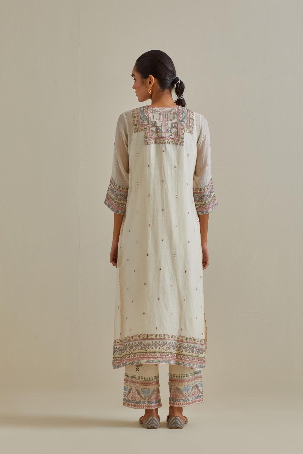 Pink and off-white cotton chanderi straight kurta set with yoke with patchwork and silk thread embroidery highlighted with mirror, sequins, tassels and braids.