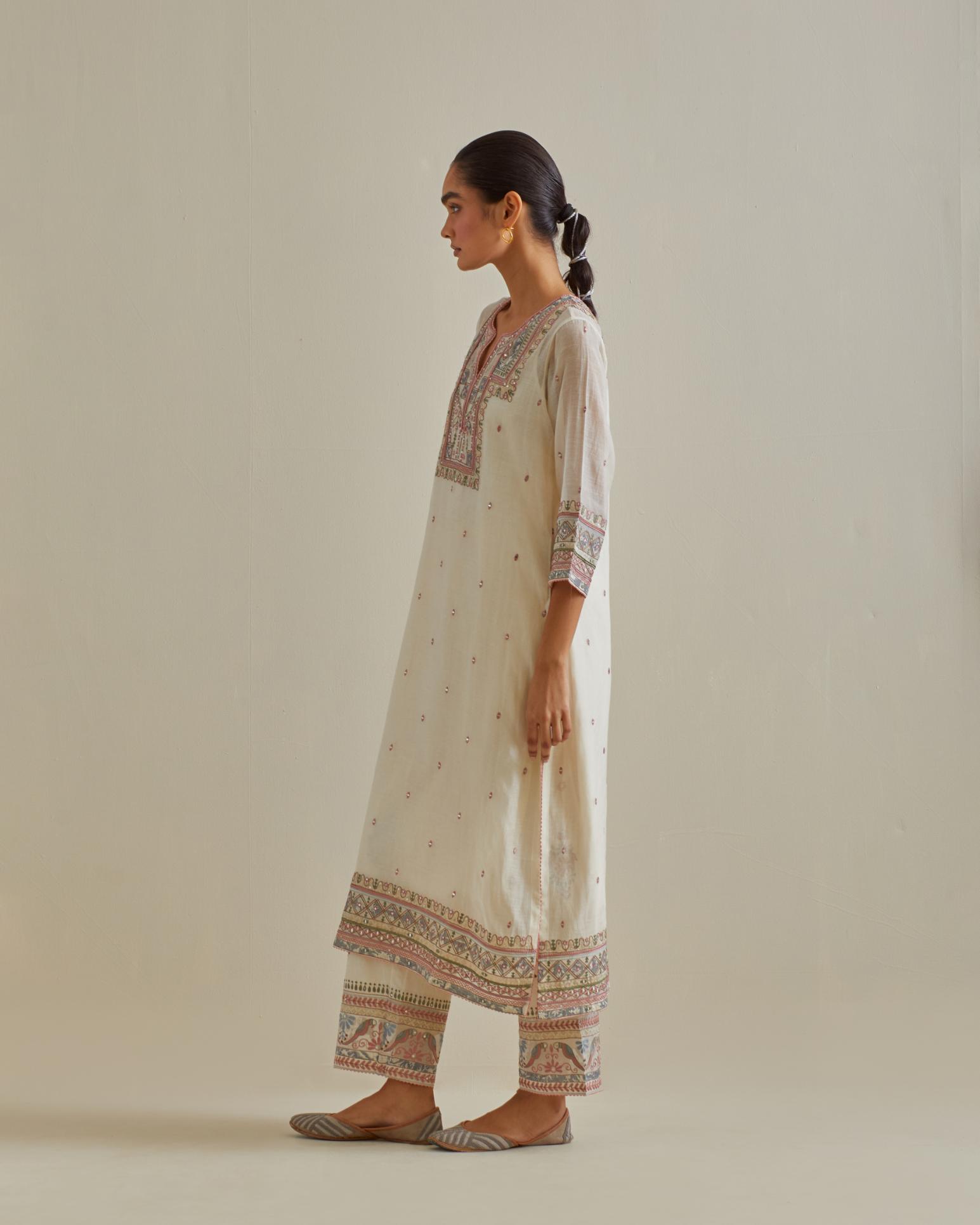 Pink and off-white cotton chanderi straight kurta set with yoke with patchwork and silk thread embroidery highlighted with mirror, sequins, tassels and braids.