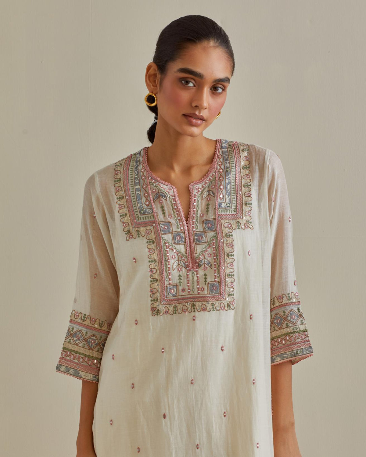 Pink and off-white cotton chanderi straight kurta set with yoke with patchwork and silk thread embroidery highlighted with mirror, sequins, tassels and braids.