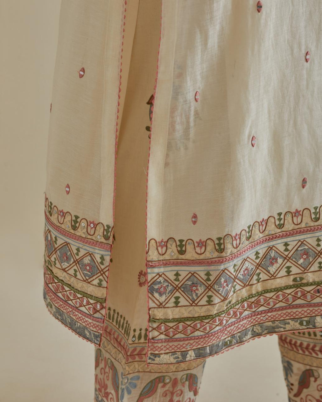 Pink and off-white cotton chanderi straight kurta set with yoke with patchwork and silk thread embroidery highlighted with mirror, sequins, tassels and braids.