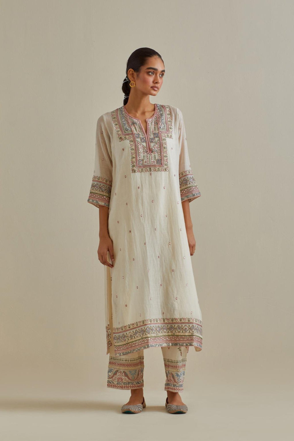 Pink and off-white cotton chanderi straight kurta set with yoke with patchwork and silk thread embroidery highlighted with mirror, sequins, tassels and braids.