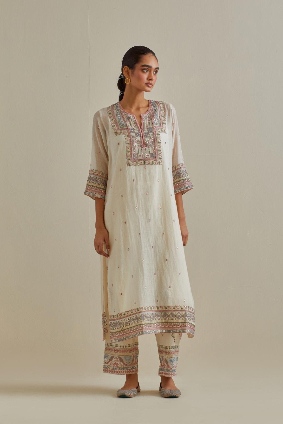 Pink and off-white cotton chanderi straight kurta set with yoke with patchwork and silk thread embroidery highlighted with mirror, sequins, tassels and braids.