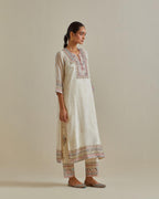 Pink and off-white cotton chanderi straight kurta set with yoke with patchwork and silk thread embroidery highlighted with mirror, sequins, tassels and braids.