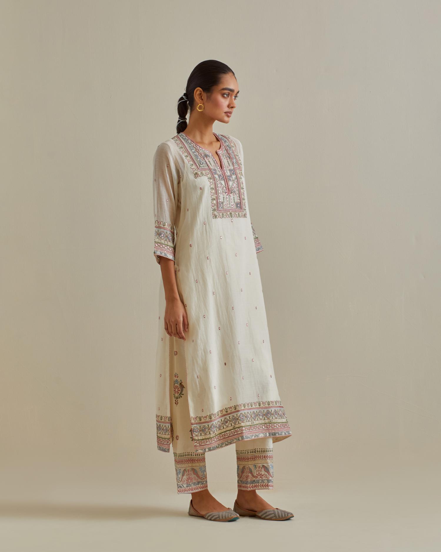Pink and off-white cotton chanderi straight kurta set with yoke with patchwork and silk thread embroidery highlighted with mirror, sequins, tassels and braids.