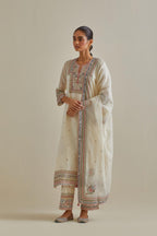 Pink and off-white cotton chanderi straight kurta set with yoke with patchwork and silk thread embroidery highlighted with mirror, sequins, tassels and braids.