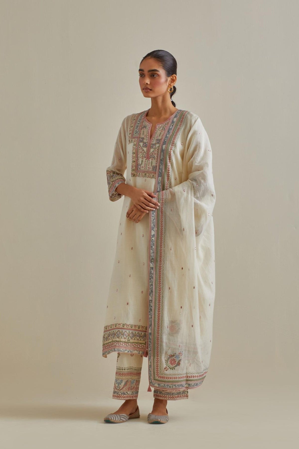 Pink and off-white cotton chanderi straight kurta set with yoke with patchwork and silk thread embroidery highlighted with mirror, sequins, tassels and braids.