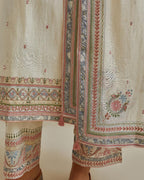 Pink and off-white cotton chanderi straight kurta set with yoke with patchwork and silk thread embroidery highlighted with mirror, sequins, tassels and braids.