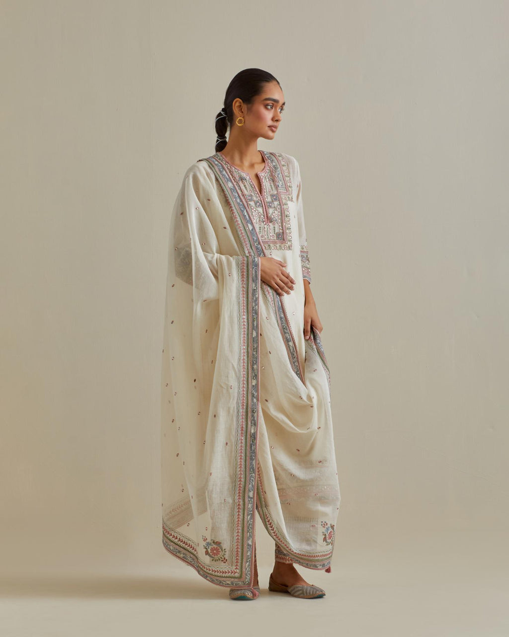 Pink and off-white cotton chanderi straight kurta set with yoke with patchwork and silk thread embroidery highlighted with mirror, sequins, tassels and braids.