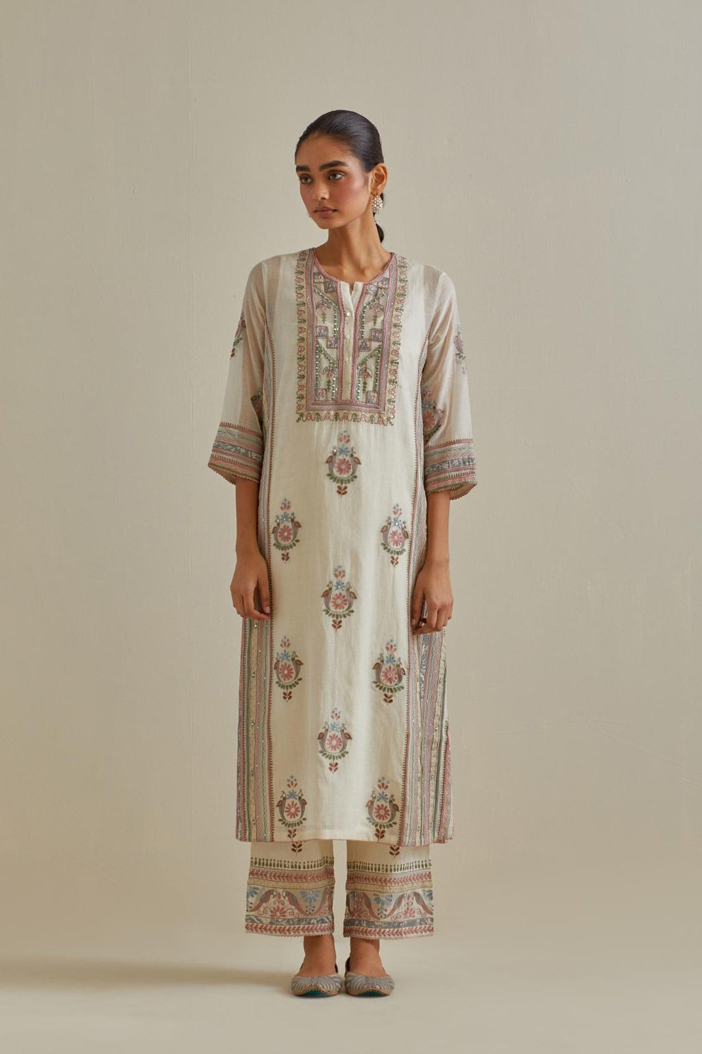 Pink and off-white cotton chanderi straight kurta set with yoke and side panels. It has allover patchwork and silk thread embroidery, highlighted with mirror, sequins, tassels and braids.