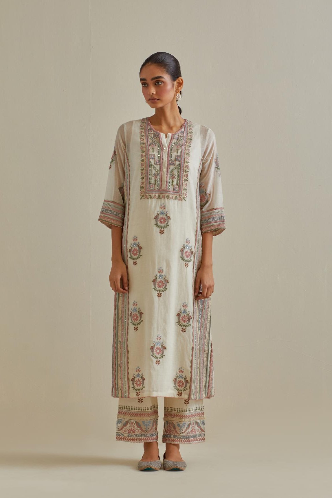 Pink and off-white cotton chanderi straight kurta set with yoke and side panels. It has allover patchwork and silk thread embroidery, highlighted with mirror, sequins, tassels and braids.