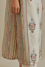 Pink and off-white cotton chanderi straight kurta set with yoke and side panels. It has allover patchwork and silk thread embroidery, highlighted with mirror, sequins, tassels and braids.