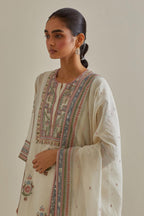 Pink and off-white cotton chanderi straight kurta set with yoke and side panels. It has allover patchwork and silk thread embroidery, highlighted with mirror, sequins, tassels and braids.
