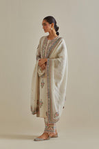 Pink and off-white cotton chanderi straight kurta set with yoke and side panels. It has allover patchwork and silk thread embroidery, highlighted with mirror, sequins, tassels and braids.