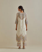 Pink and off-white cotton chanderi straight kurta set with patchwork and thread embroidery highlighted with mirrors, sequins, tassels and braids.