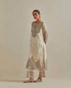 Pink and off-white cotton chanderi straight kurta set with patchwork and thread embroidery highlighted with mirrors, sequins, tassels and braids.